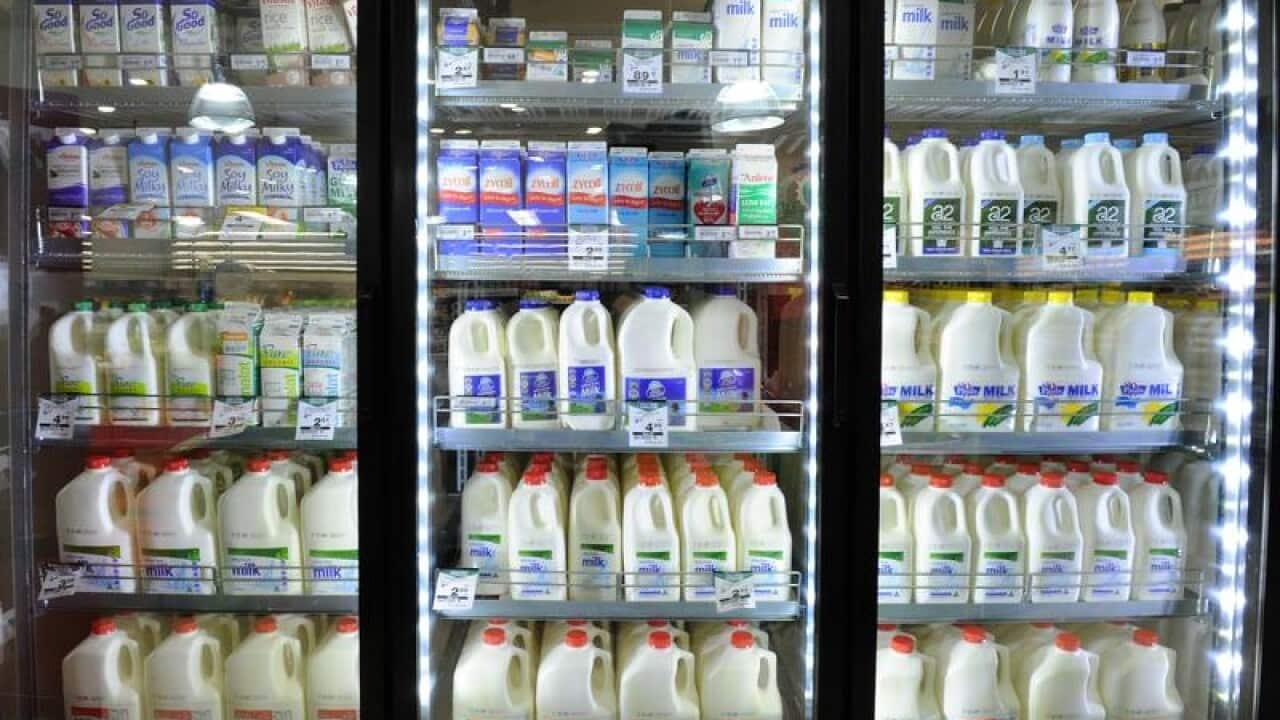Milk on sale inside a Woolworths grocery store.