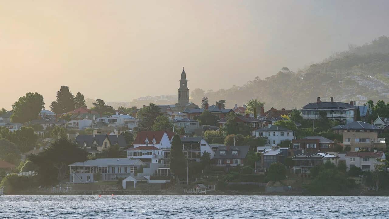 Houses along the Derwent River are seen in the late afternoon light as boats make their way to the finish line of the 2017 Sydney to Hobart Yacht Race in Hobart, Wednesday, December 27, 2017. (AAP Image/Rob Blakers) NO ARCHIVING, EDITORIAL USE ONLY