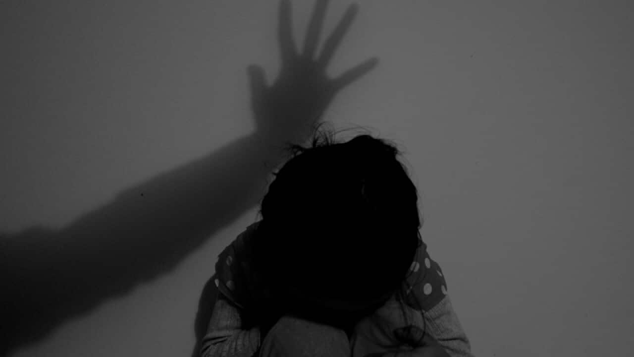A child poses for a photograph to illustrate abuse
