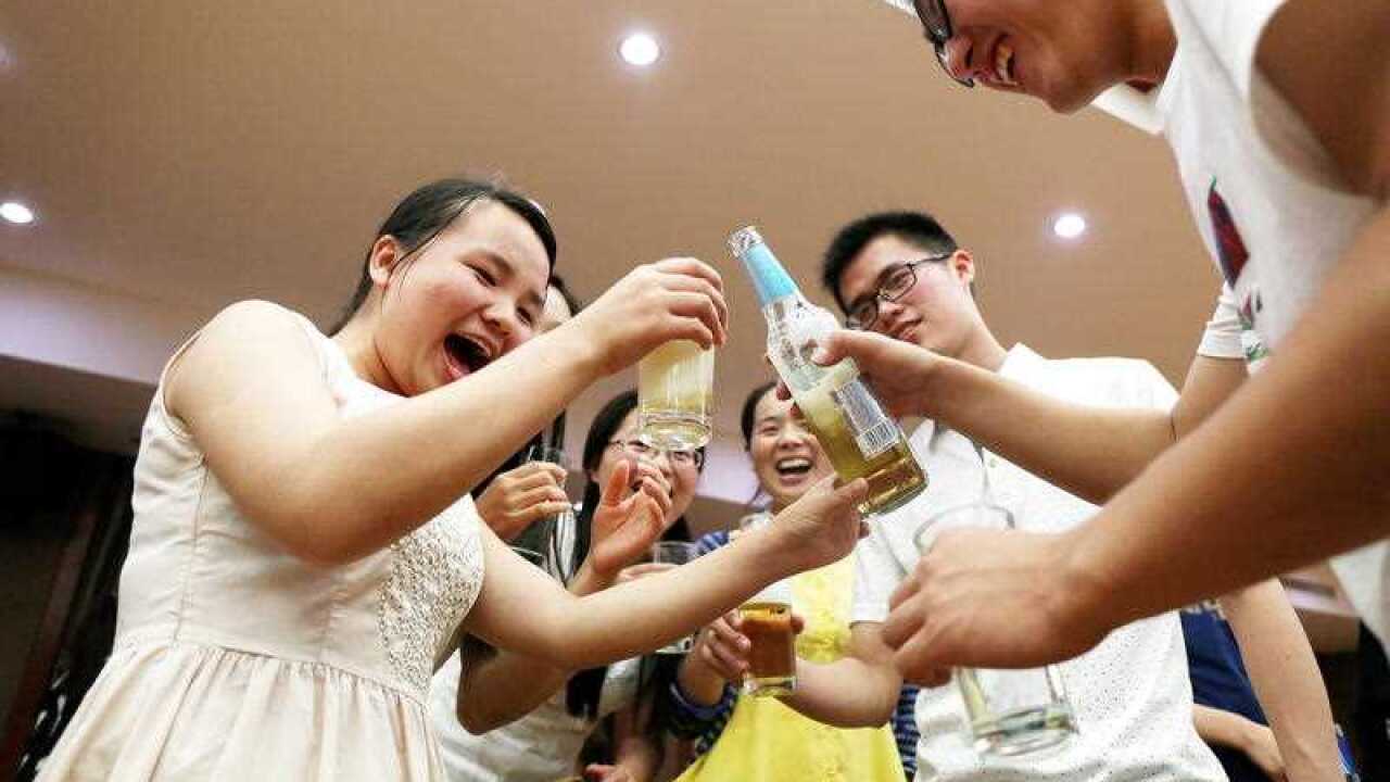Chinese graduates drink beer at a graduation dinner in Anqing city, east China's Anhui province