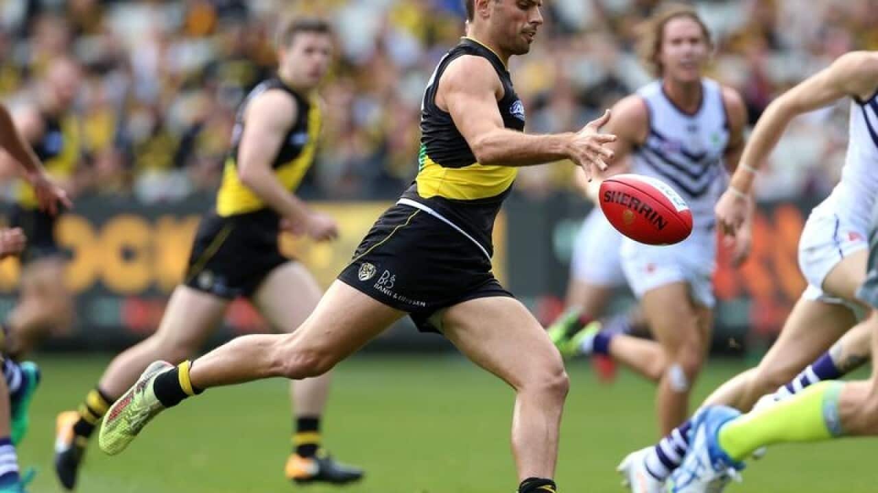 Sam Lloyd of the Tigers kicks a goal against the Dockers.