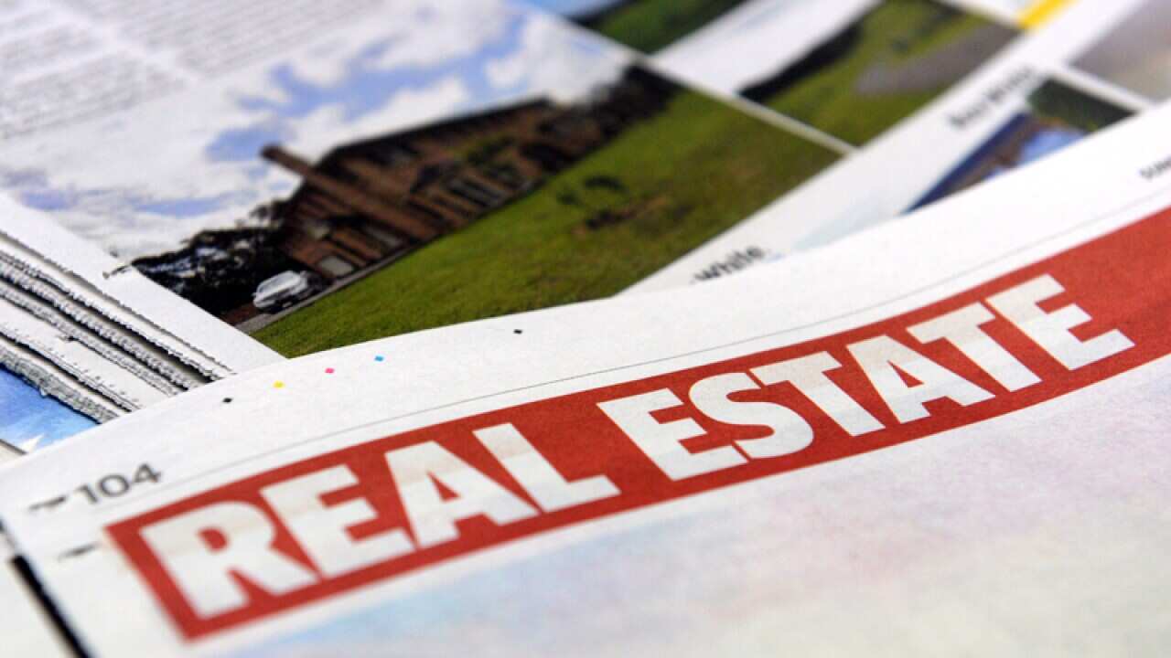 Real estate advertising in a newspaper in Brisbane