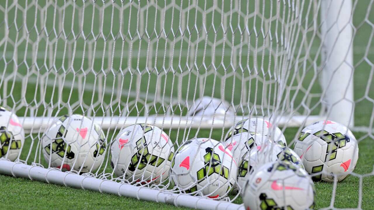 Generic photos of soccer balls in the nets during the warm-up session