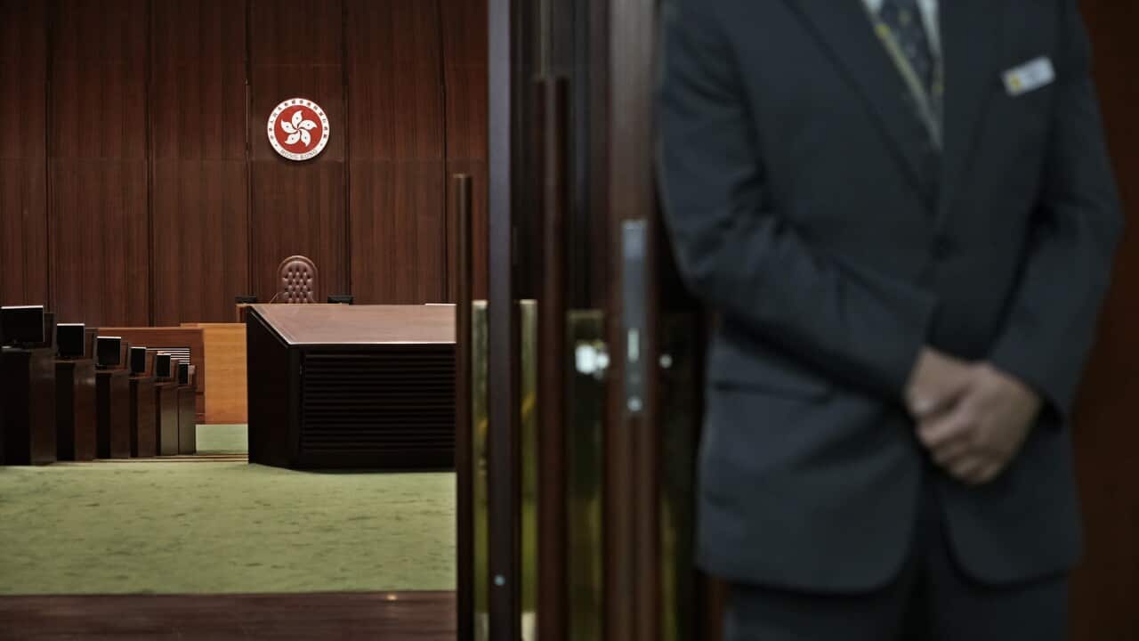 A security officer stands guard at the entrance of the Hong Kong legislative chamber