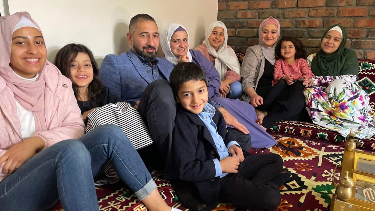 Radwa Alobait (centre, in purple) with her husband and children at their home in Adelaide’s northern suburbs.