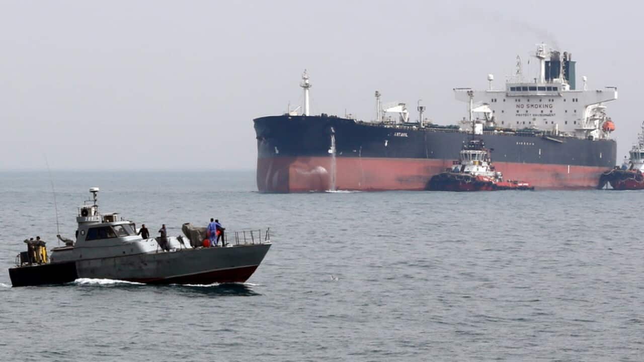 Iranian patrol boat next to oil tanker