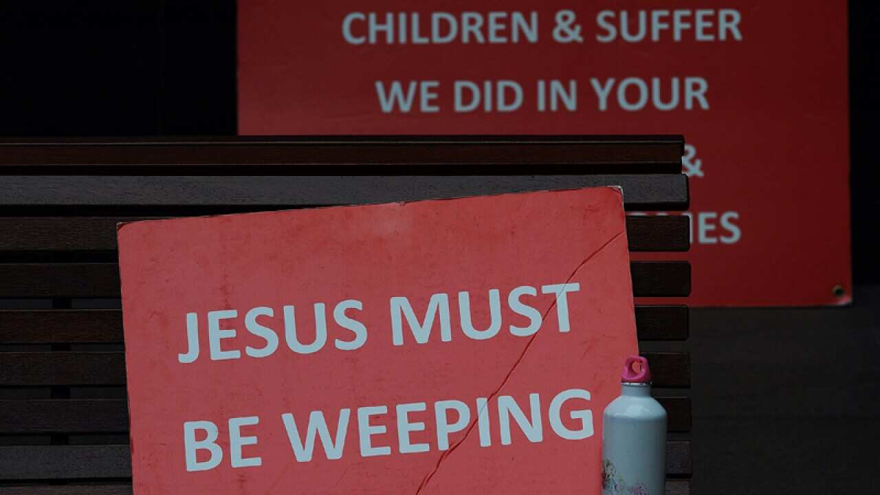 Signs placed by supporters and victims outside the Royal Commission.