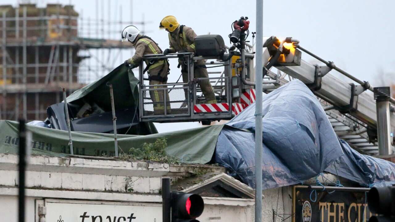 Rescuers after a plane crashed into the roof of a pub in Glasgow