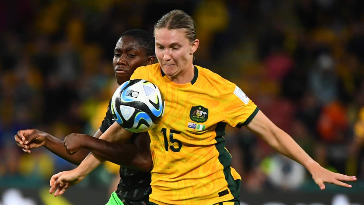 An Australian football player and a Nigerian football player.