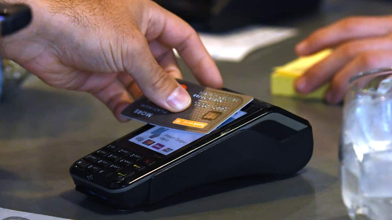 A stock image showing credit card payment at a cafe in Brisbane