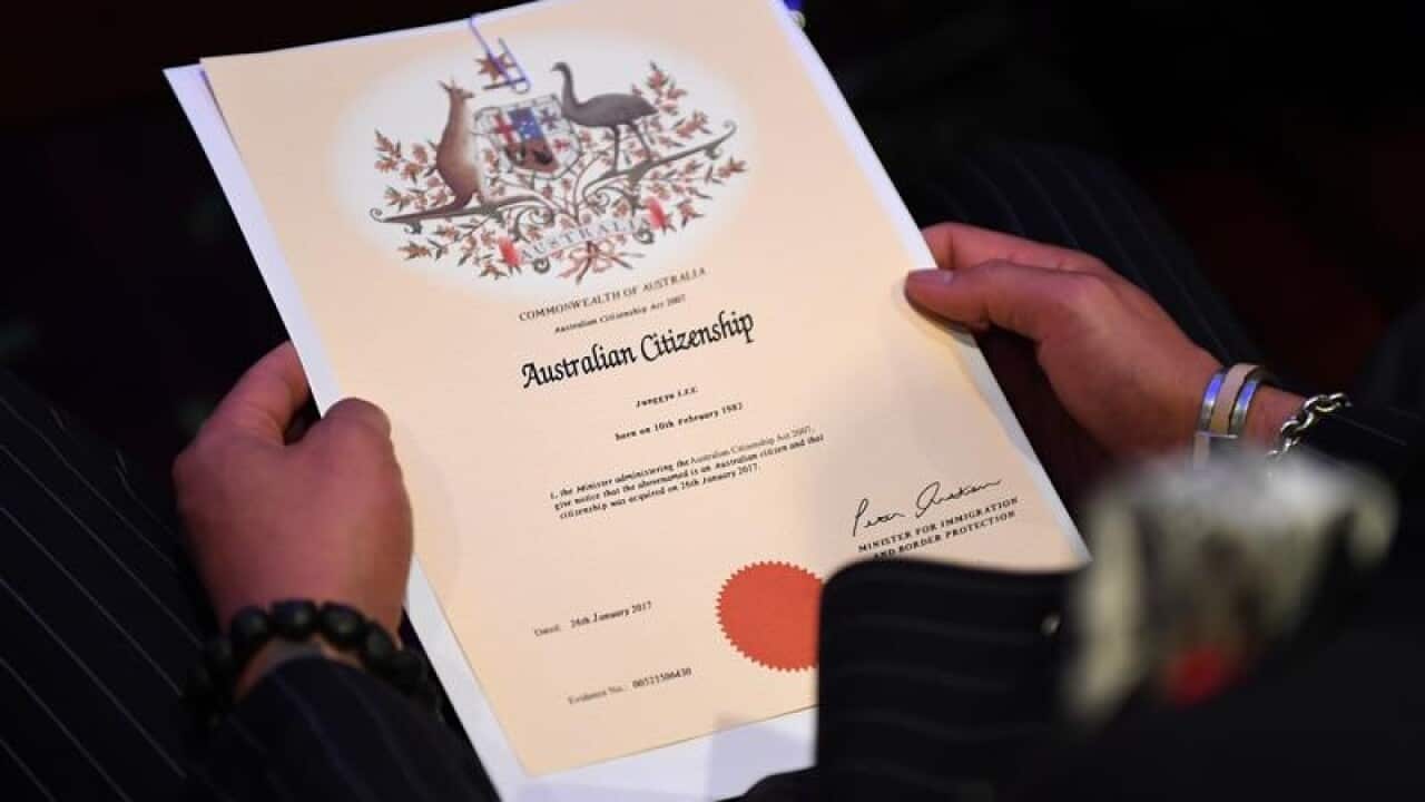 Australian citizenship recipient holds his certificate
