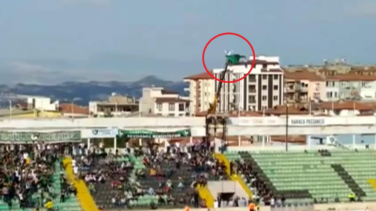 A football fan banned from the stadium hired a crane to watch his team play on the weekend. 