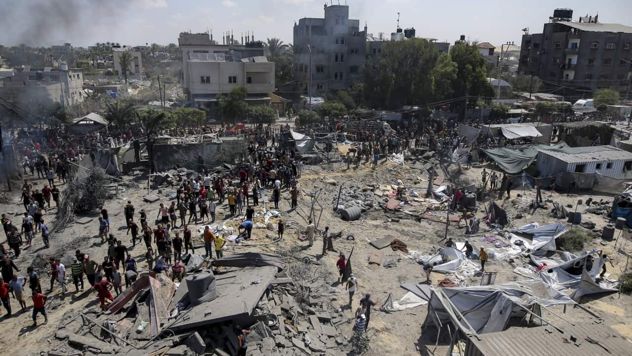 People inspect the site hit by an Israeli bombardment which killed Hamas military commander Mohammed Deif (AAP)