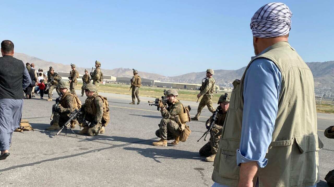 U.S soldiers take a position to guard along a perimeter at the international airport in Kabul