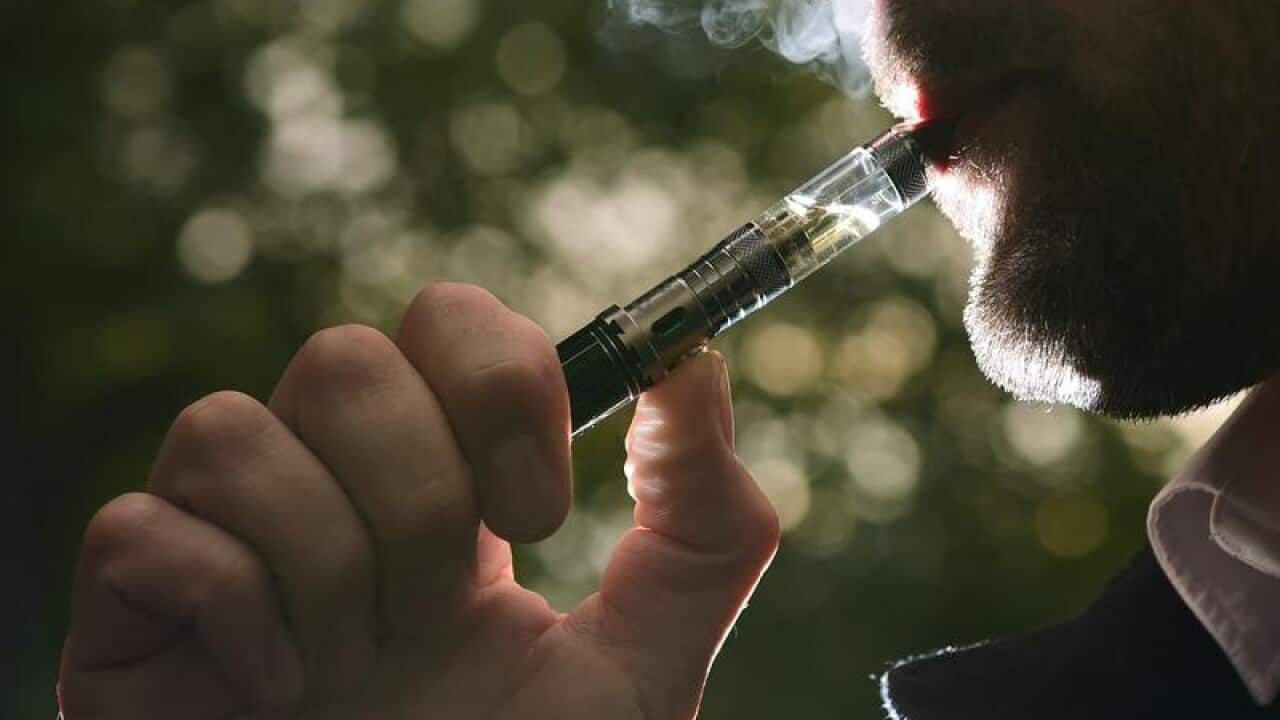 A man smoking an electronic cigarette