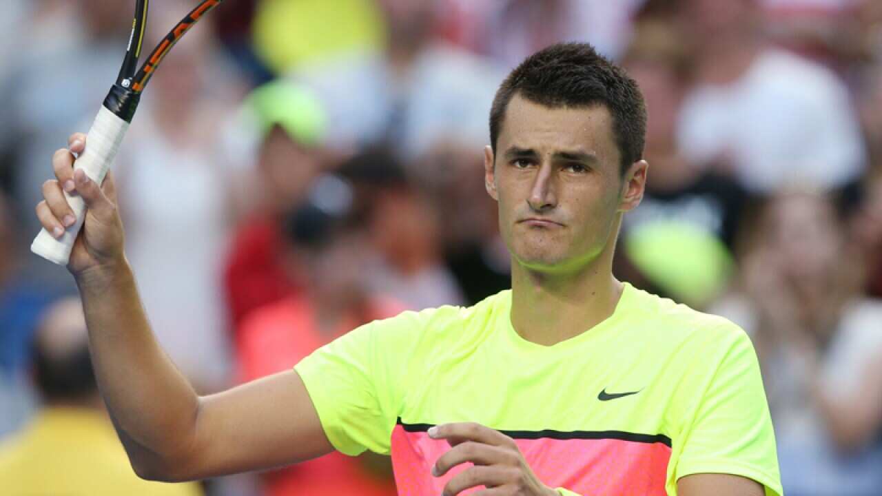 Bernard Tomic celebrates winning his match against Sam Groth