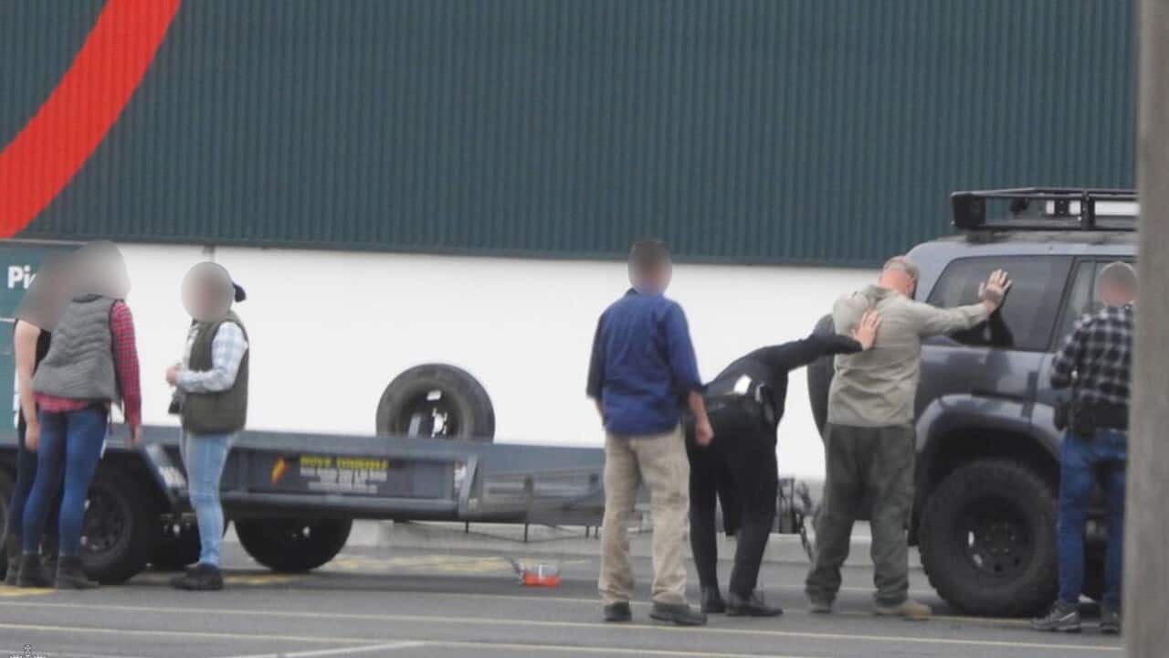 A man is arrested by AFP police outside an Armidale hardware store, and taken to Armidale Police Station.