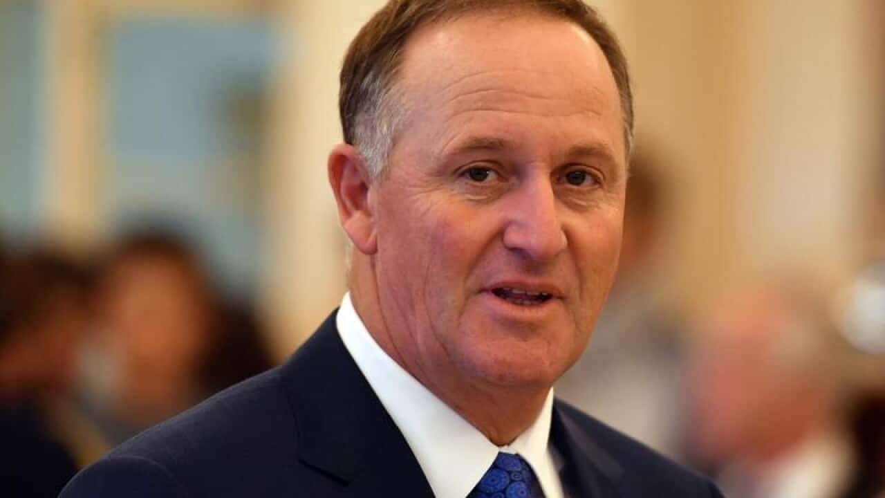 New Zealand's former prime minister John Key arrives at a ceremony.