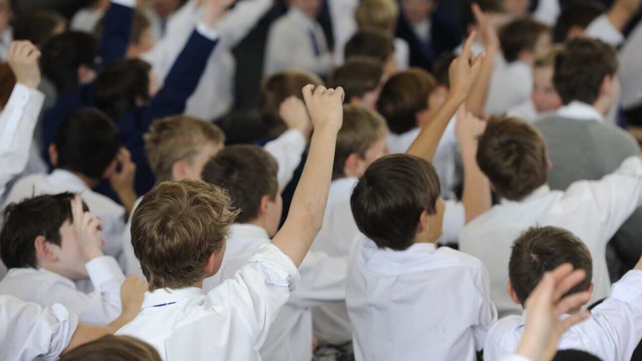 Students sit during a talk at private college