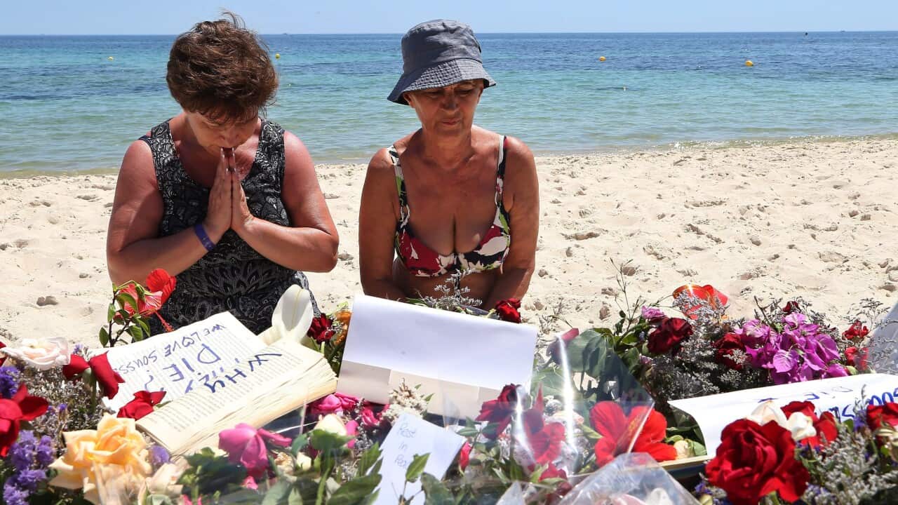 A Tourist prays beside flowers placed in tribute to the people killed in a terror attack on a beach in front of the imperial Marhaba Hotel in Sousse,Tunisia, 28 June 2015 (EPA/MOHAMED MESSARA)