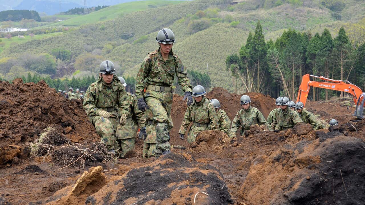 Self Defense Force soldiers search for missing people at the site of a landslide in Kumamoto prefecture.