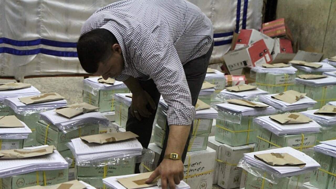 An Egyptian official inspects boxes containing ballot cards for the Egyptian parliamentary elections on October 17. (AFP)