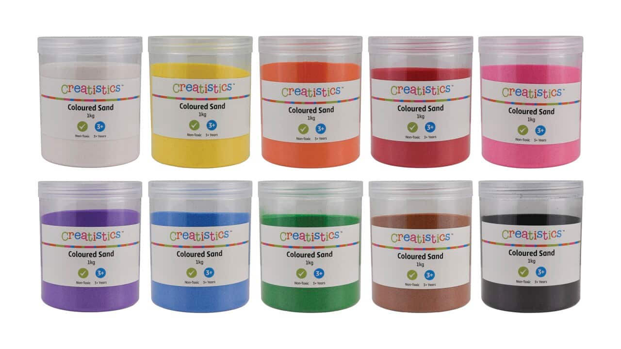 Buckets of coloured sand products against a white background.
