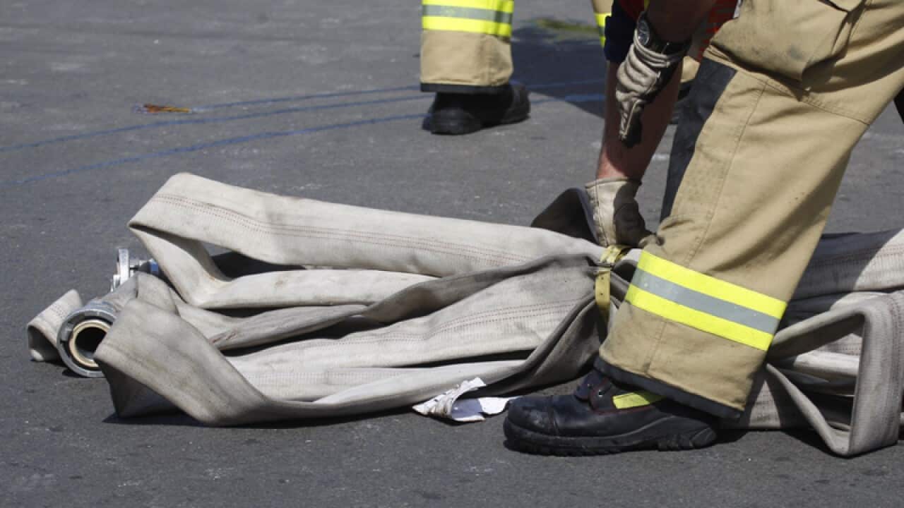 A firefighter at the scene of a fire