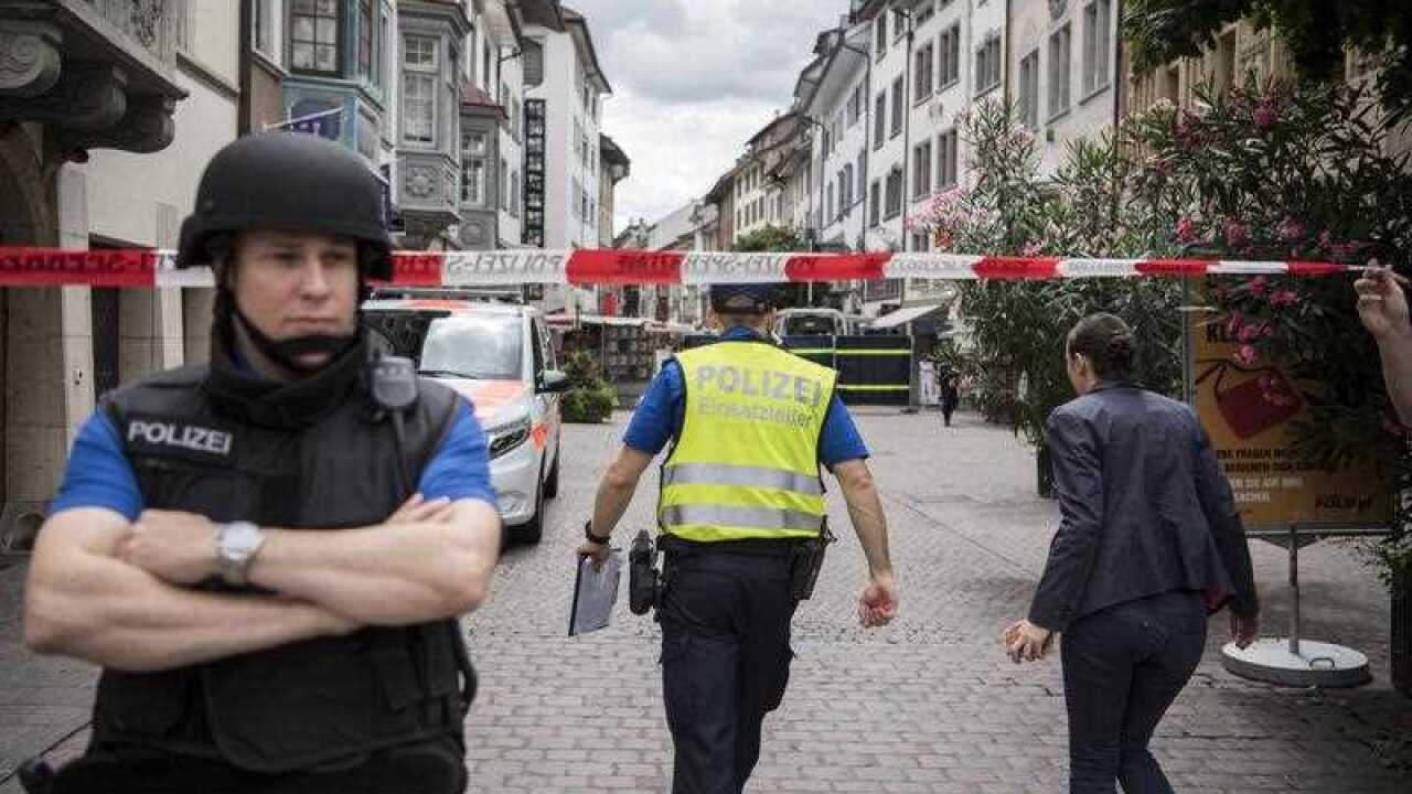 Armed police officers seal off the old town of Schaffhausen as officers search for an unidentified man, following an attack with a chainsaw in Schaffhausen, Switzerland, 24 July 2017. 