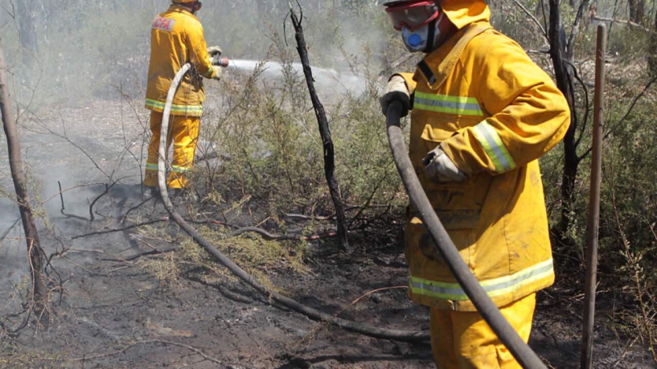 Country Fire Authority firefighters work to mop out hotspots