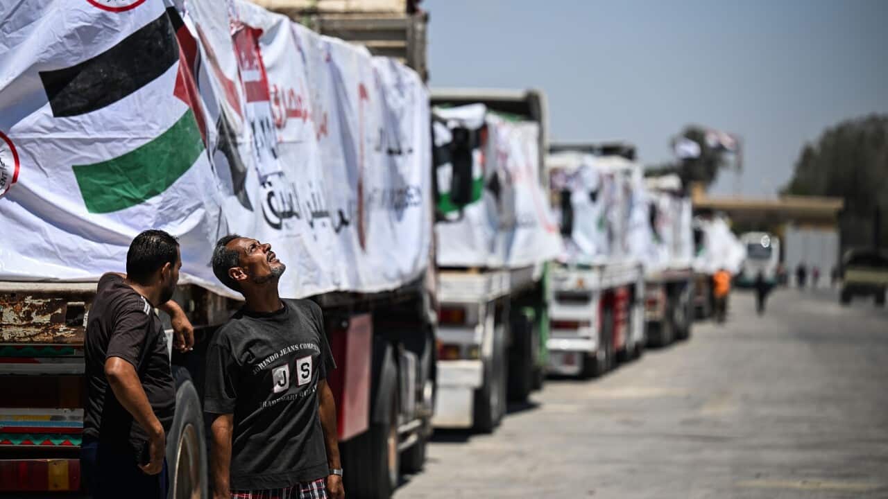 Trucks with humanitarian aid wait at Rafah border