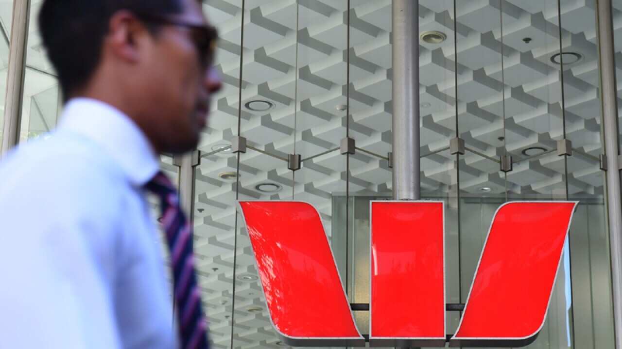 A pedestrians walks past a Westpac Bank branch in Central Sydney