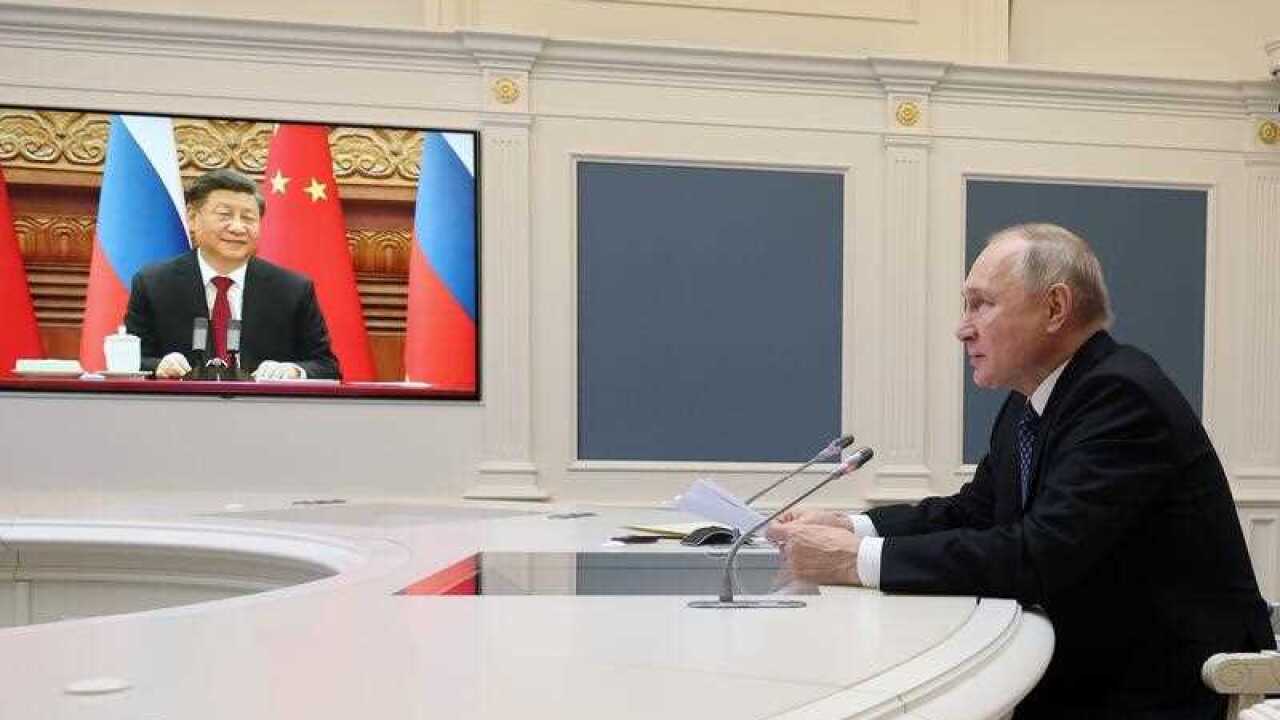 Russian President Vladimir Putin speaks during a meeting with Chinese President Xi Jinping, seen onscreen, via a video conference at the Kremlin in Moscow, Russia, Friday, Dec. 30, 2022. (Mikhail Klimentyev, Sputnik, Kremlin Pool Photo via AP)