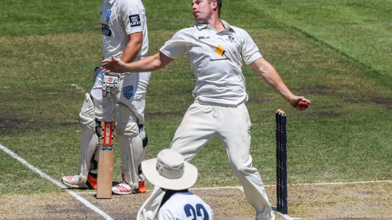 Jon Holland of Victoria bowling the ball