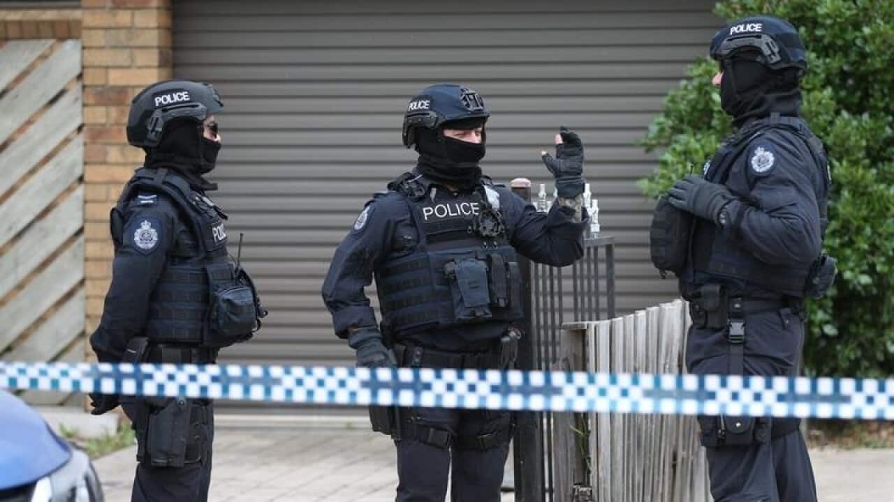 Police are seen at one of the sites