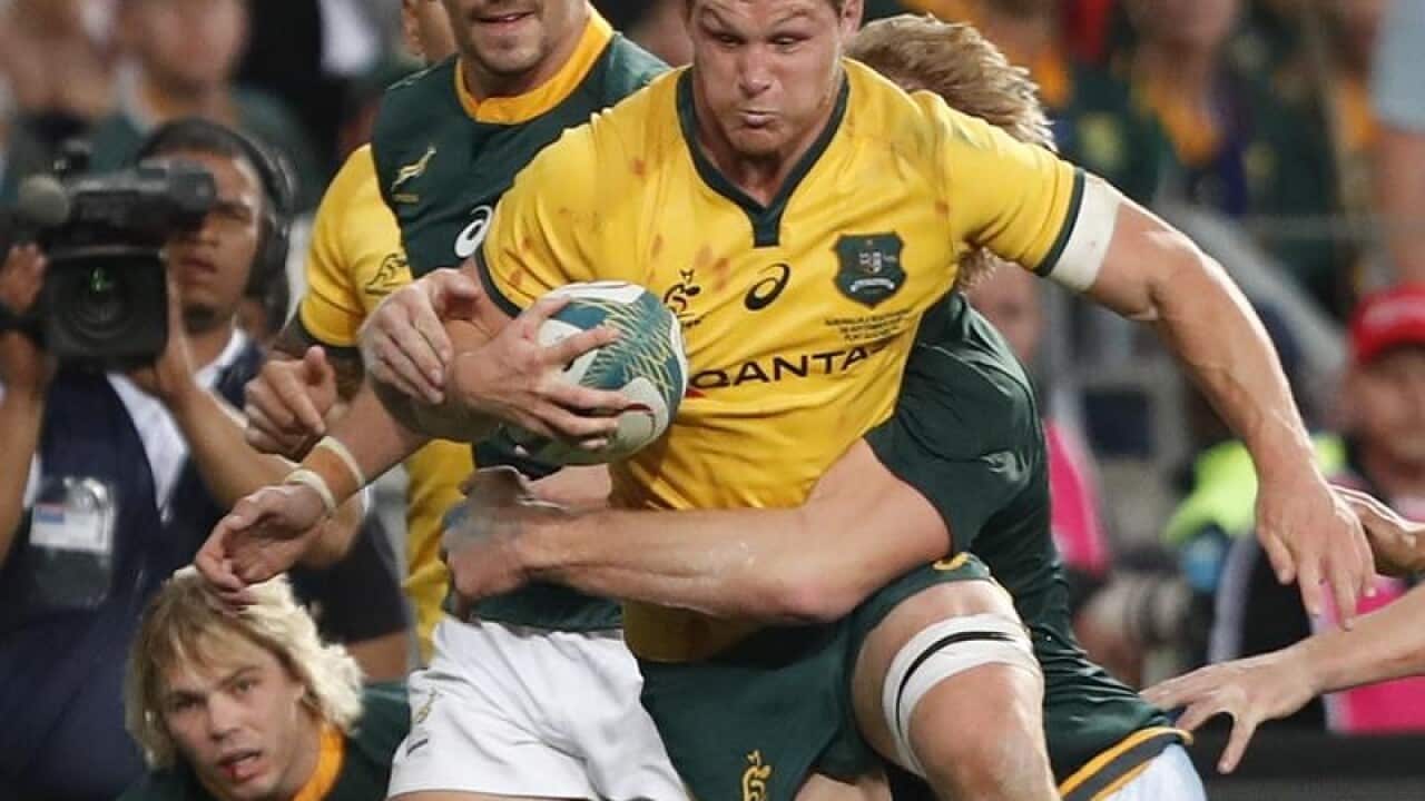 Wallabies captain Michael Hooper being tackled by Springboks players.