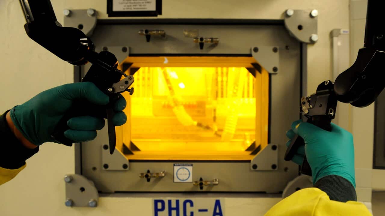 A technician uses a hot cell which shields radioactive material at the Opal nuclear research reactor at Lucas Heights in Sydney.