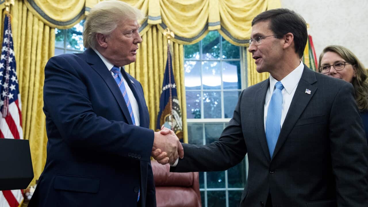 Mark Esper shakes Donald Trump's hand after being sworn-in as US Secretary of Defense in July 2019.