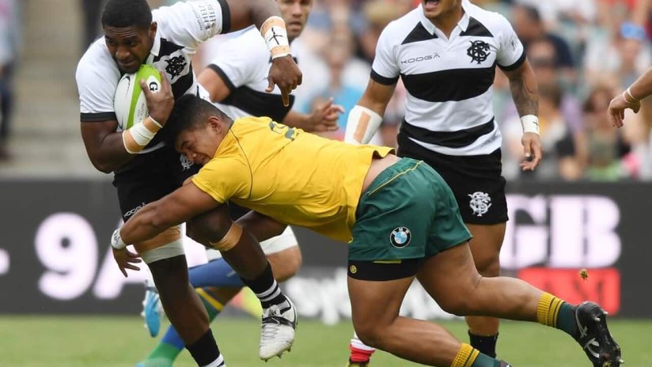 Jordan Uelese tackles a Barbarians player