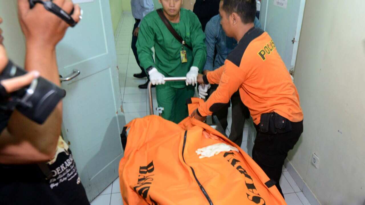 The body of a Japanese scuba diver is transported to a hospital