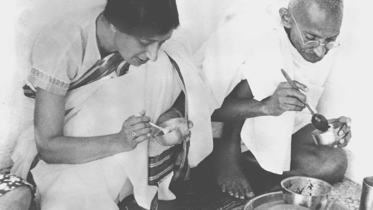 Mahatma Gandhi, right, sits down to share a meal with a guest in his home in India on May 22, 1936.  (AP Photo)