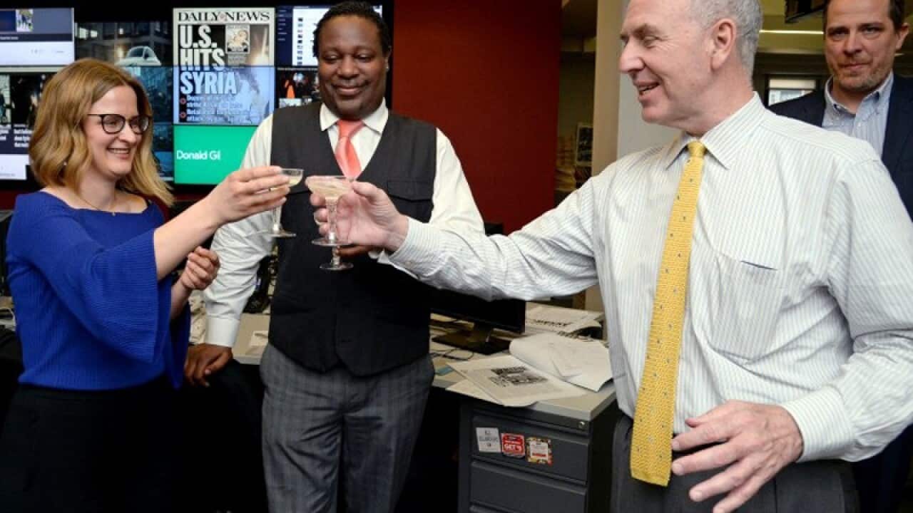 New York Daily News reporter Sarah Ryley (L) toasts her Pulitzer Prize