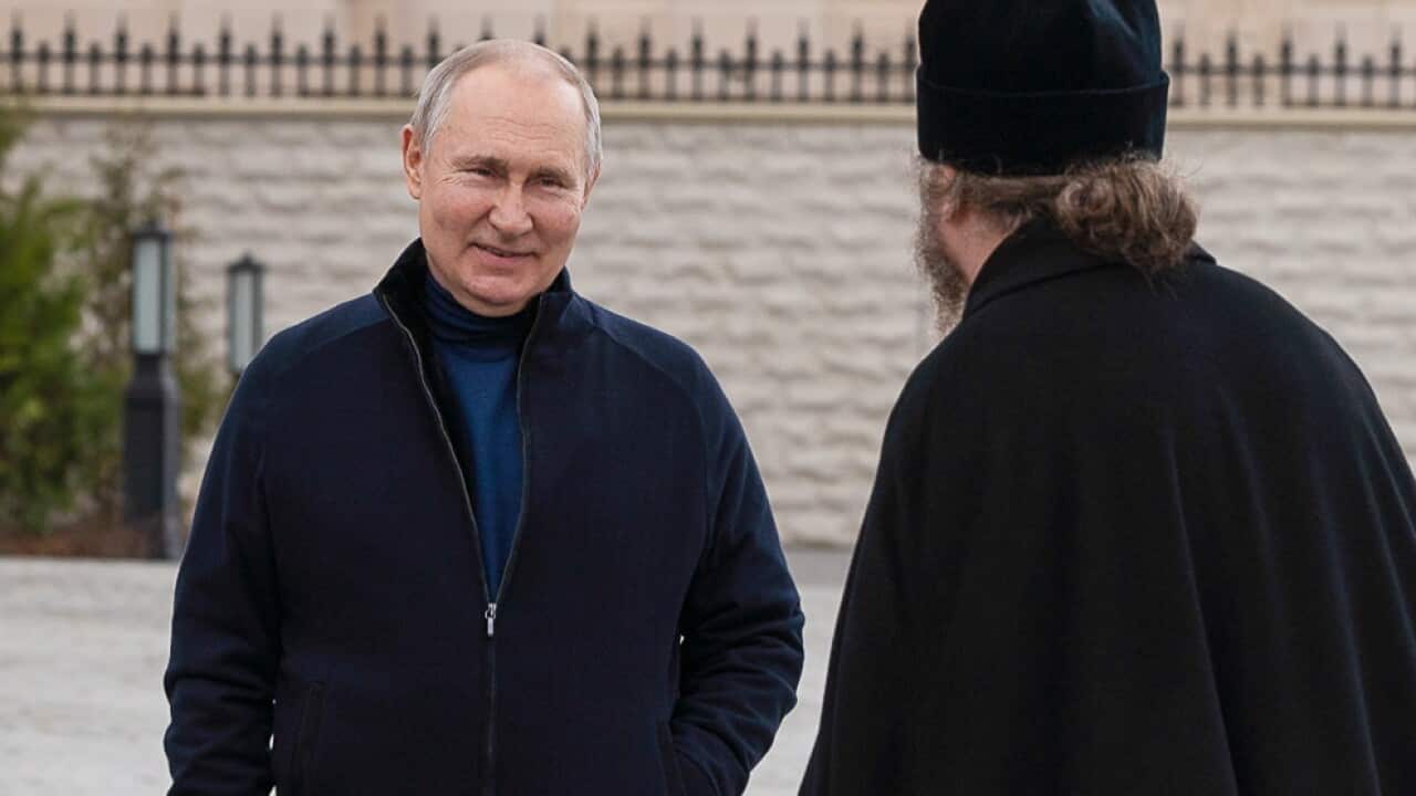 Three men standing outside.