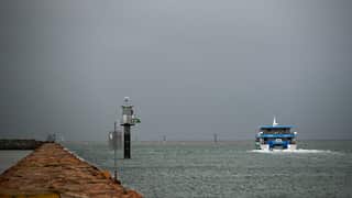 A ferry on the sea near a port
