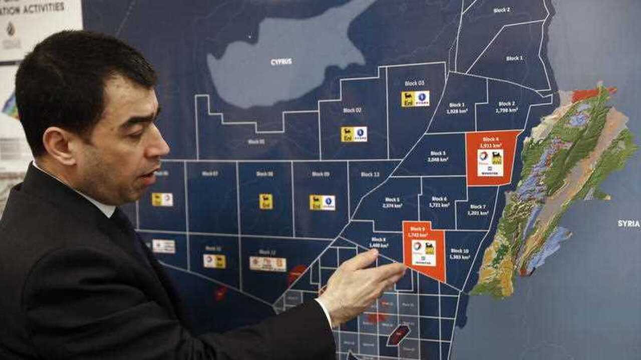 Lebanon's Energy Minister Cesar Abi Khalil, explains on the map about the offshore block 9 which Israel claims, during an interview with the Associated Press at his office, in Beirut