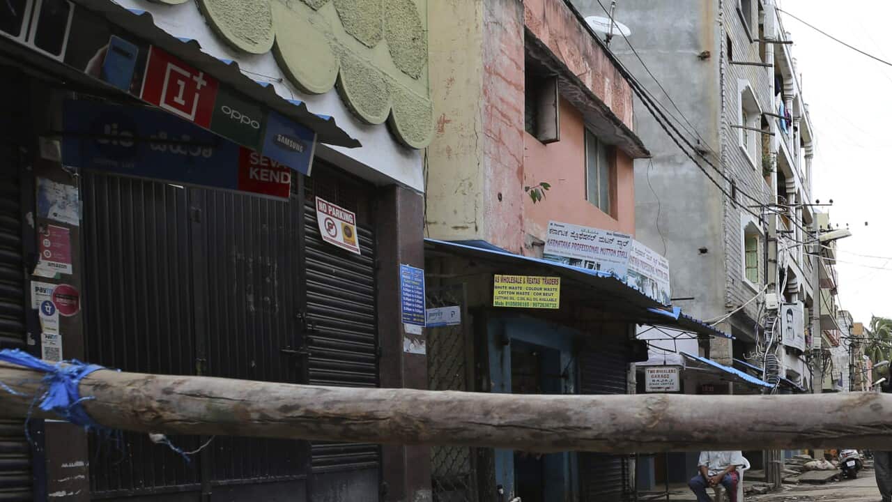 A notice displayed by authorities on a makeshift barricade set up to restrict entry in a containment zone during lockdown in Bengaluru