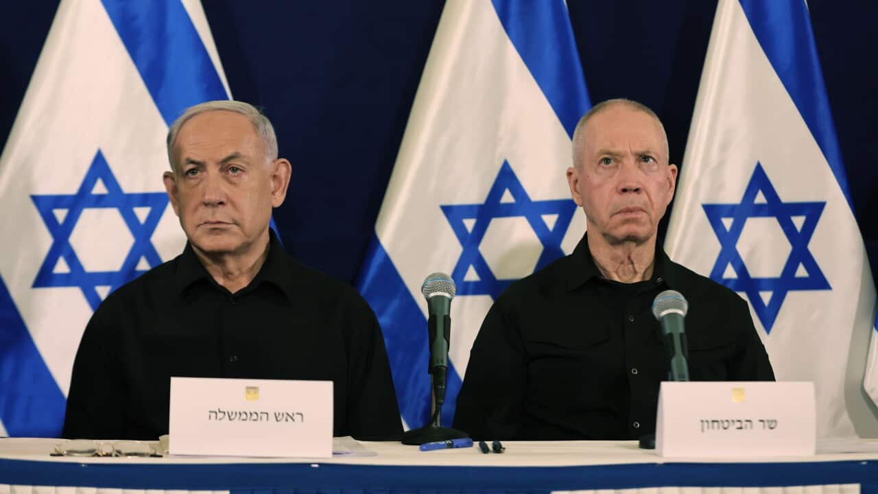 Benjamin Netanyahu and Yoav Gallant with Israeli flags hanging in the background.