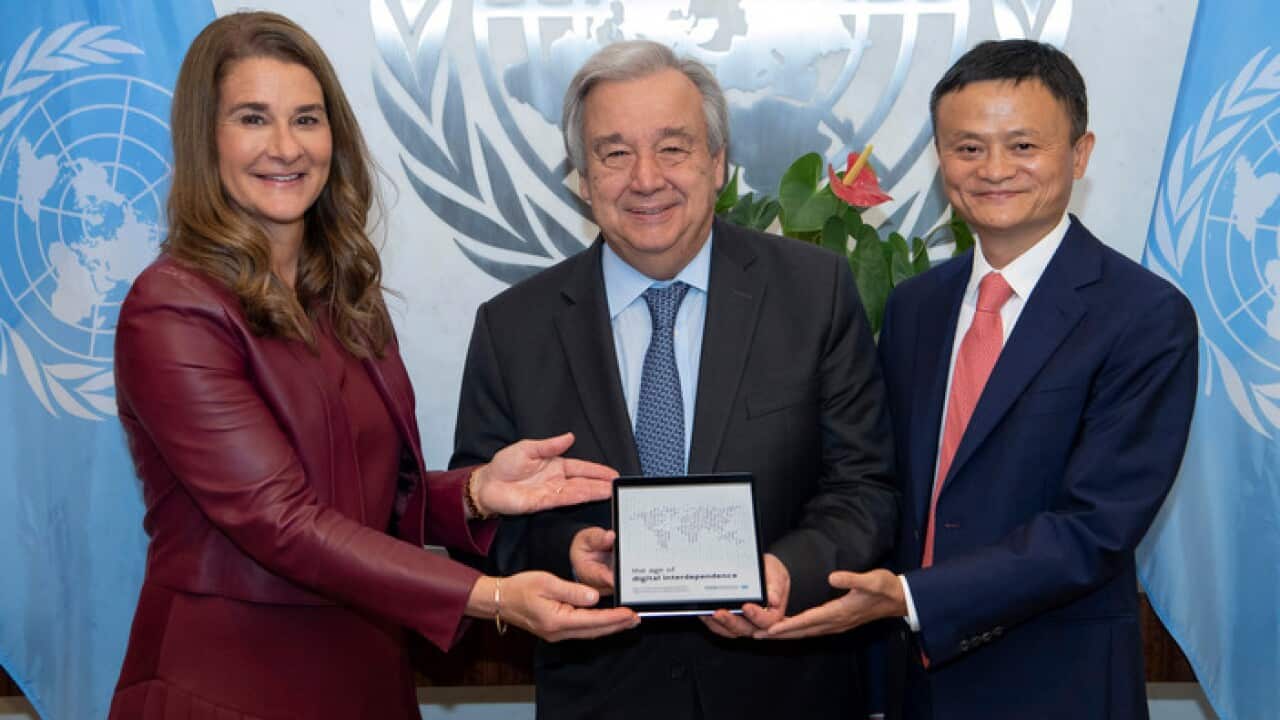 Melinda Gates and Jack Ma present UN Secretary-General Antonio Guterres, center, with the "The Age Digital of Digital Independence" report