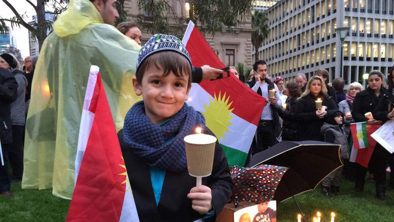 A 5-year-old boy attends a refugee vigil in Melbourne (AAP)
