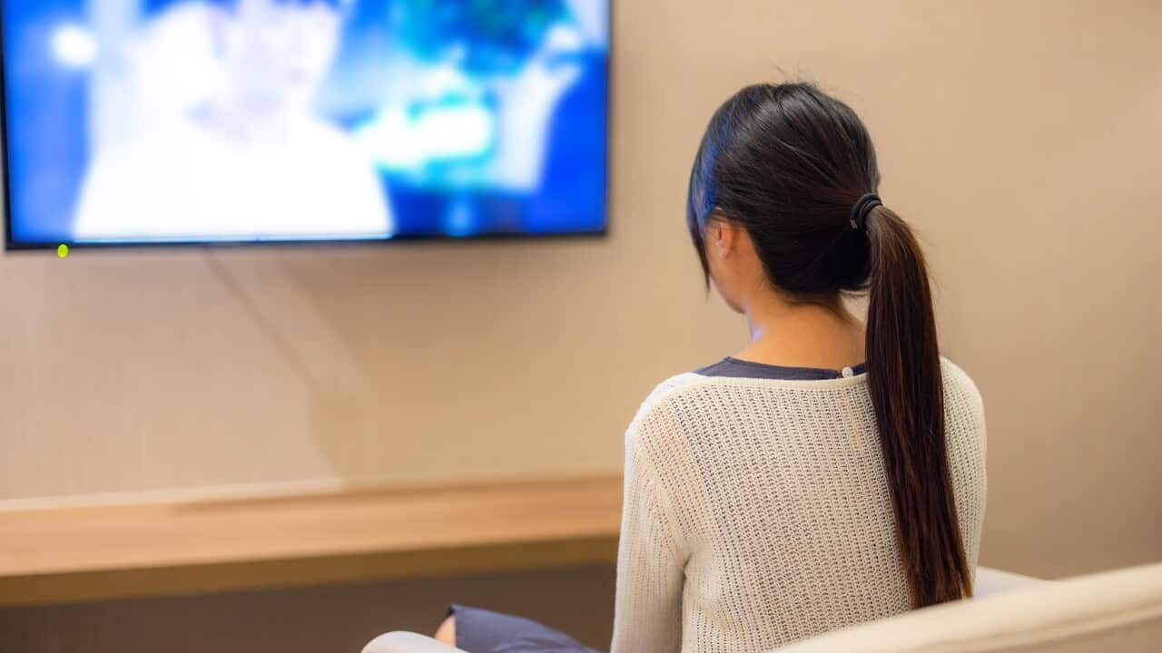 Woman watch TV at home in the evening